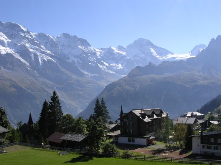 The cowshed at Busenalp is clearly above the tree line on the right side of the dark middle distance ridge. This picture was taken from the writer’s home in Murren.