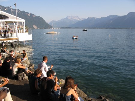 Festivalgoers enjoy a pre concert drink on the shores of Lake Geneva