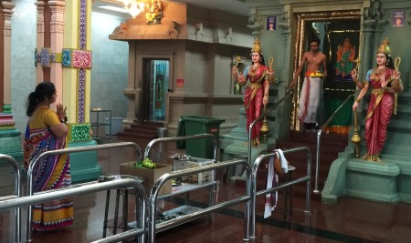 Devotee greets Priest at the Sri Maha Mariamman Temple.