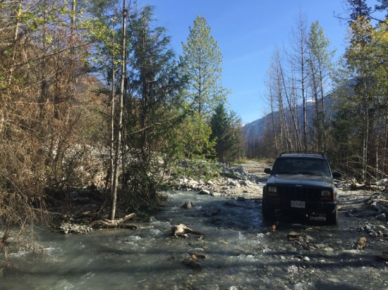 Instead of running under the road a land slip has diverted the creek onto the road. When editing this image I noticed Pete re-emerging in the distance on the road!